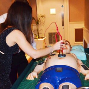 Person playing Giant Operation game with oversized board and tweezers.